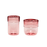 Zwei verschieden grosse rosa Glasbehaelter. Nutzbar z. B. im Badezimmer.