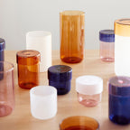 Verschiedene Pop Glaeser auf einem Tisch schoen arrangiert.